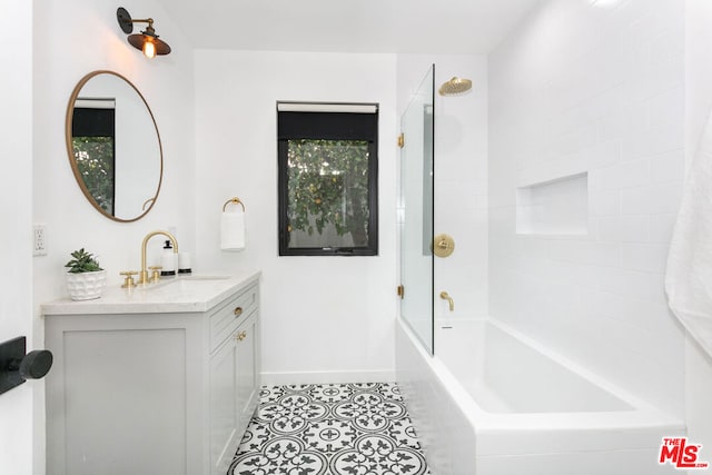 bathroom featuring tiled shower / bath combo and vanity