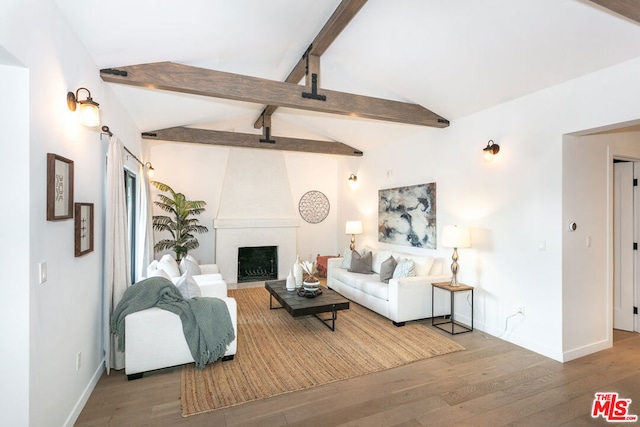 living room with a fireplace, hardwood / wood-style flooring, and lofted ceiling with beams