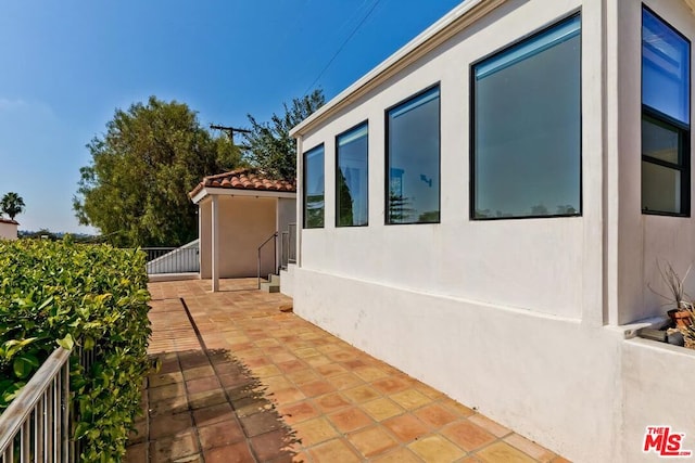 view of side of property featuring a patio area