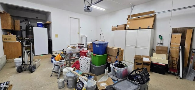 garage featuring a garage door opener and white refrigerator