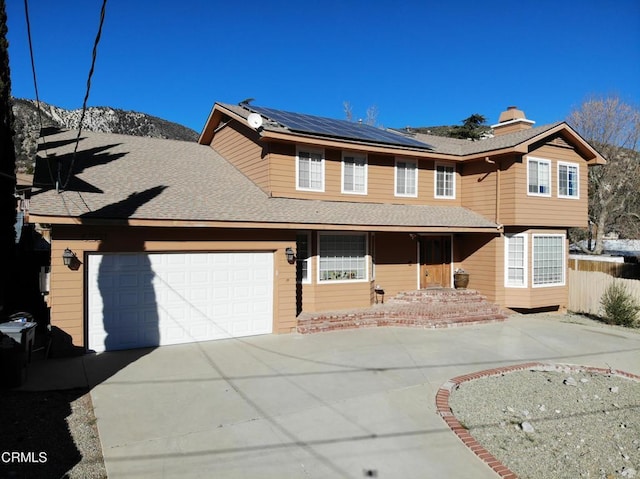 front facade featuring solar panels and a garage