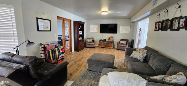 living room featuring light hardwood / wood-style floors and french doors