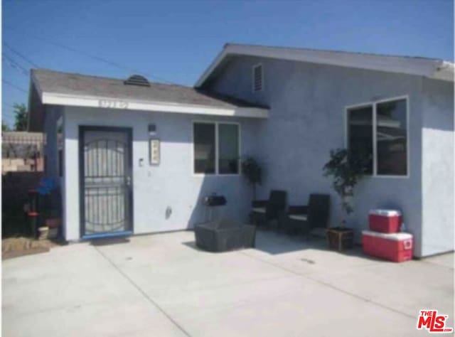 rear view of house featuring a patio