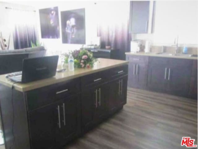 kitchen featuring sink, dark wood-type flooring, and white cabinets