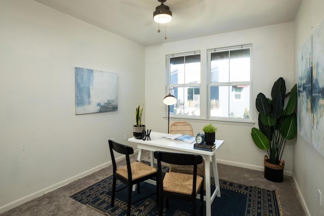 office space featuring ceiling fan and dark carpet