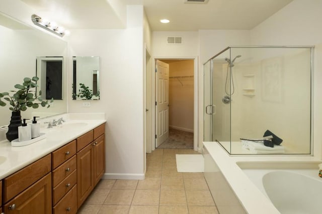 bathroom with vanity, plus walk in shower, and tile patterned flooring