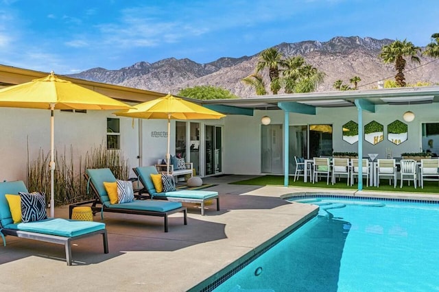 back of house with a mountain view and a patio