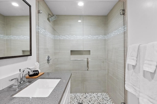 bathroom with an enclosed shower and vanity