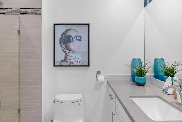 bathroom featuring toilet and vanity