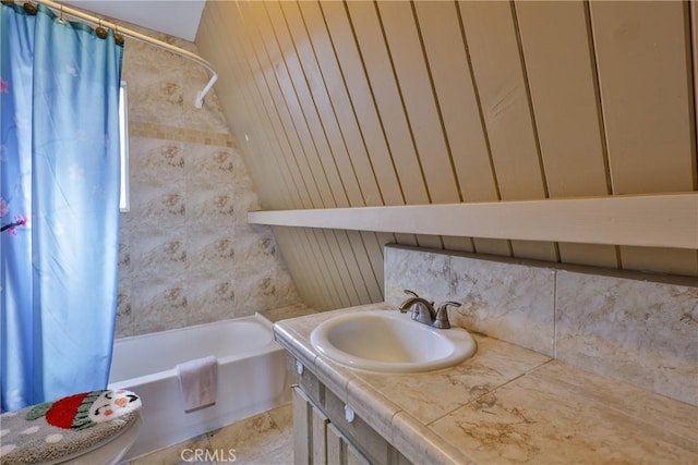 bathroom featuring decorative backsplash, shower / bath combo with shower curtain, and vanity