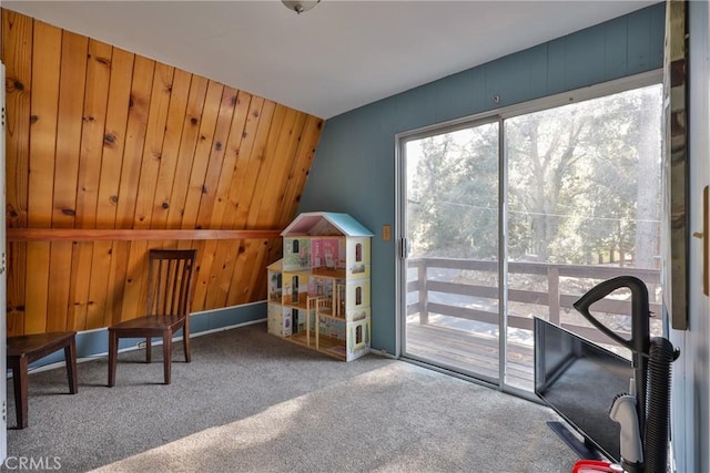 rec room with wood walls, baseboards, and carpet floors