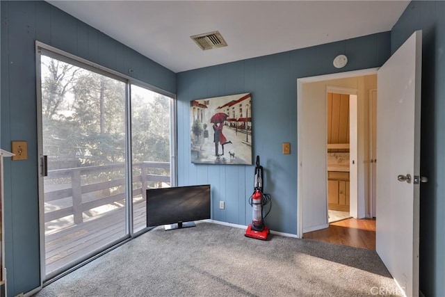 carpeted empty room with baseboards and visible vents