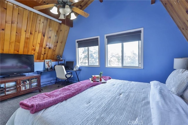 bedroom with multiple windows, ceiling fan, vaulted ceiling with beams, and carpet flooring