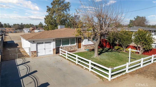 single story home featuring a garage and a front yard