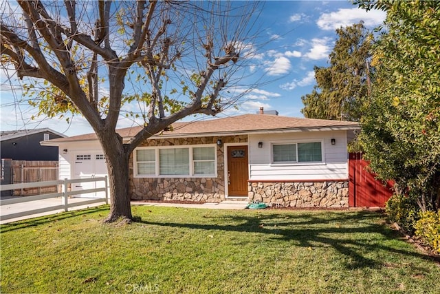 single story home featuring a garage and a front yard