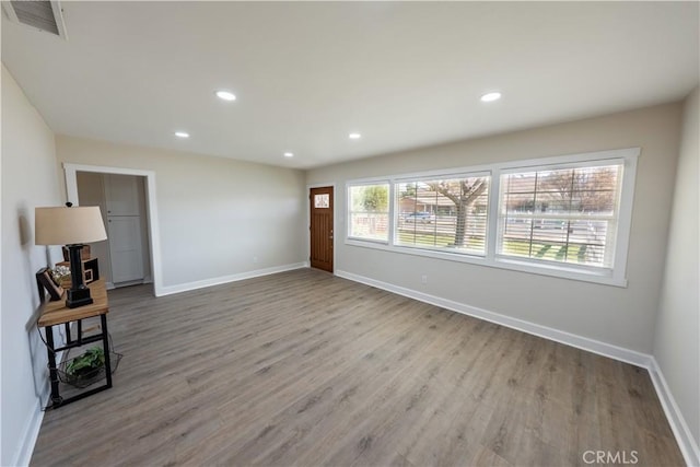 spare room with a wealth of natural light and light wood-type flooring