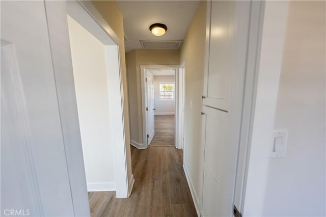 hall with hardwood / wood-style flooring