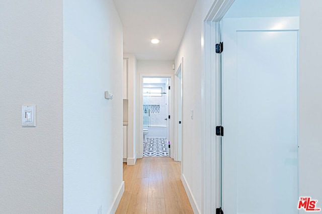 hall with light hardwood / wood-style floors