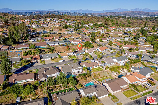 birds eye view of property with a mountain view