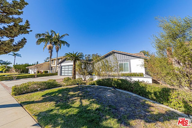 view of front of house with a front yard and a garage