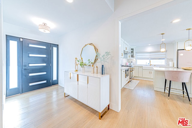 entryway featuring light hardwood / wood-style floors and sink