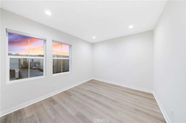 unfurnished room with light hardwood / wood-style floors