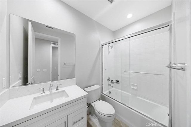 full bathroom with toilet, bath / shower combo with glass door, and vanity