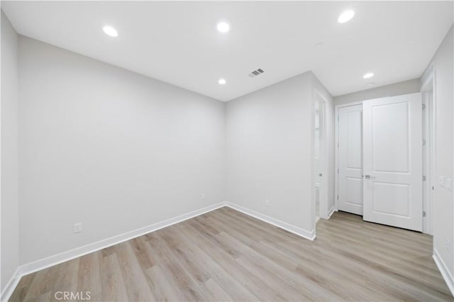 empty room with light hardwood / wood-style flooring