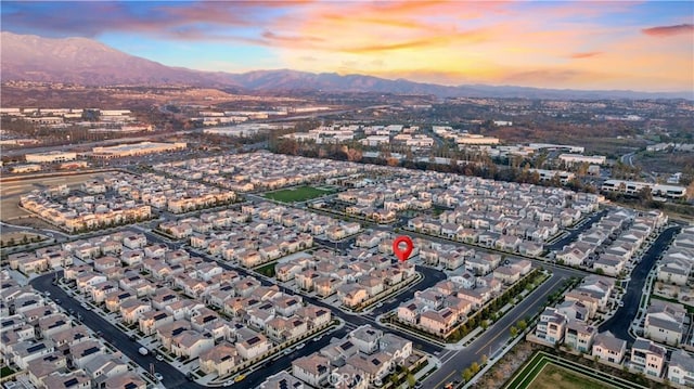 aerial view at dusk featuring a mountain view