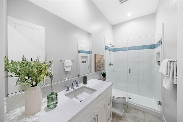 bathroom with toilet, vanity, and an enclosed shower