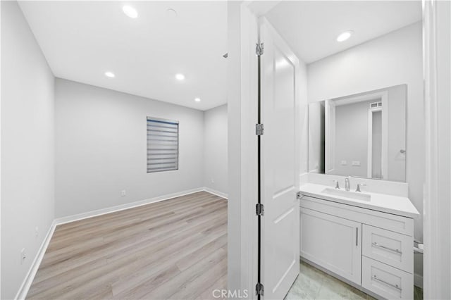 bathroom featuring hardwood / wood-style flooring and vanity