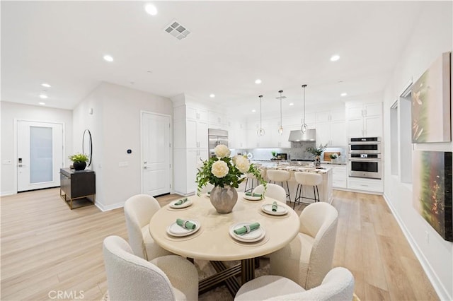 dining area with light hardwood / wood-style flooring