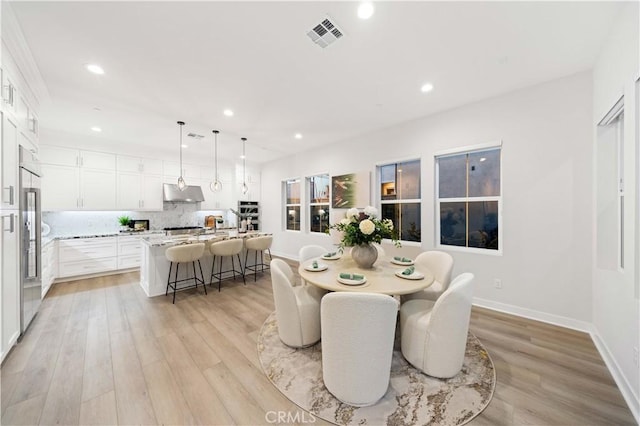 dining area featuring light wood-type flooring