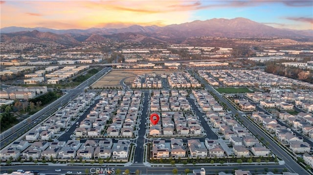 aerial view at dusk featuring a mountain view