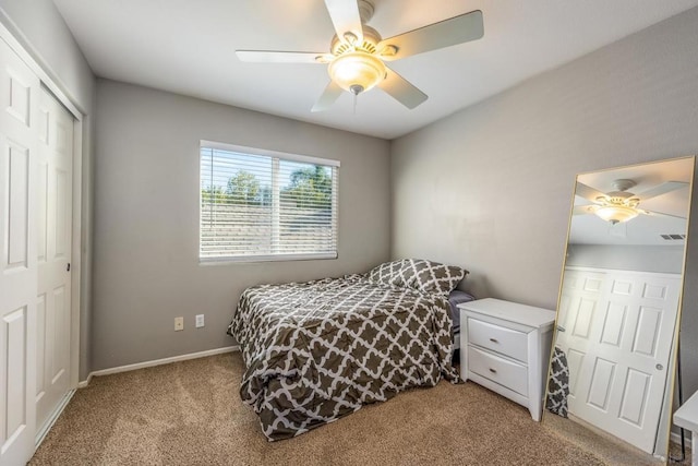 carpeted bedroom featuring ceiling fan and a closet