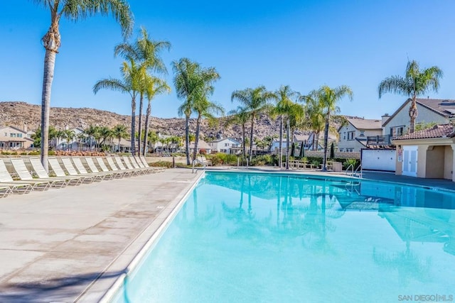 view of swimming pool with a mountain view