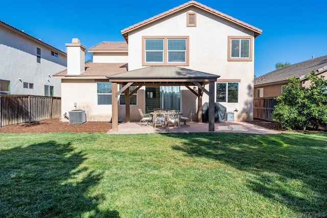 rear view of property featuring a patio area, central AC, a gazebo, and a lawn