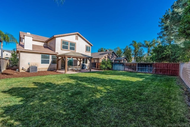 back of property featuring a patio area, a gazebo, a yard, and central air condition unit