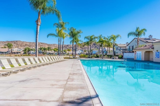 view of swimming pool with a mountain view