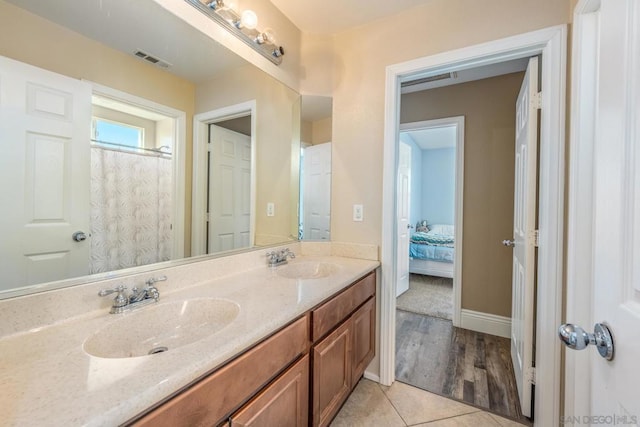 bathroom featuring tile patterned flooring and vanity