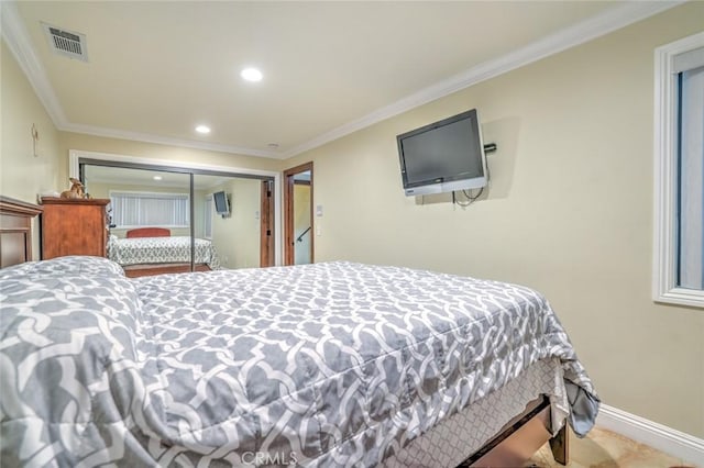 bedroom with a closet and crown molding