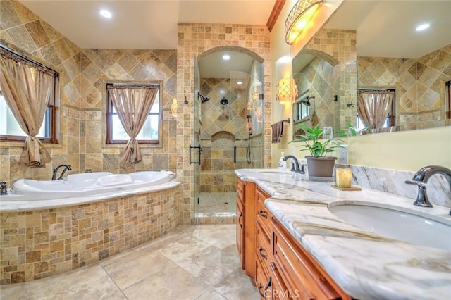 bathroom featuring vanity, tile walls, and independent shower and bath