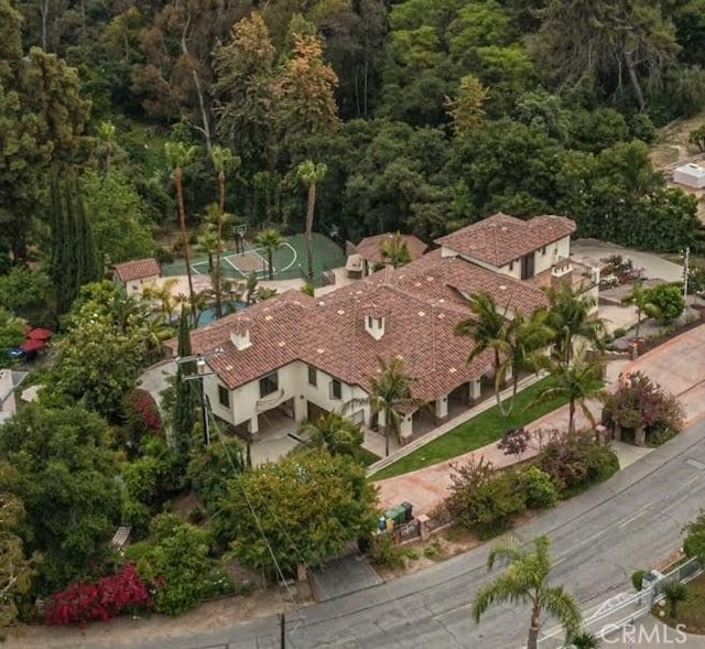 drone / aerial view featuring a wooded view