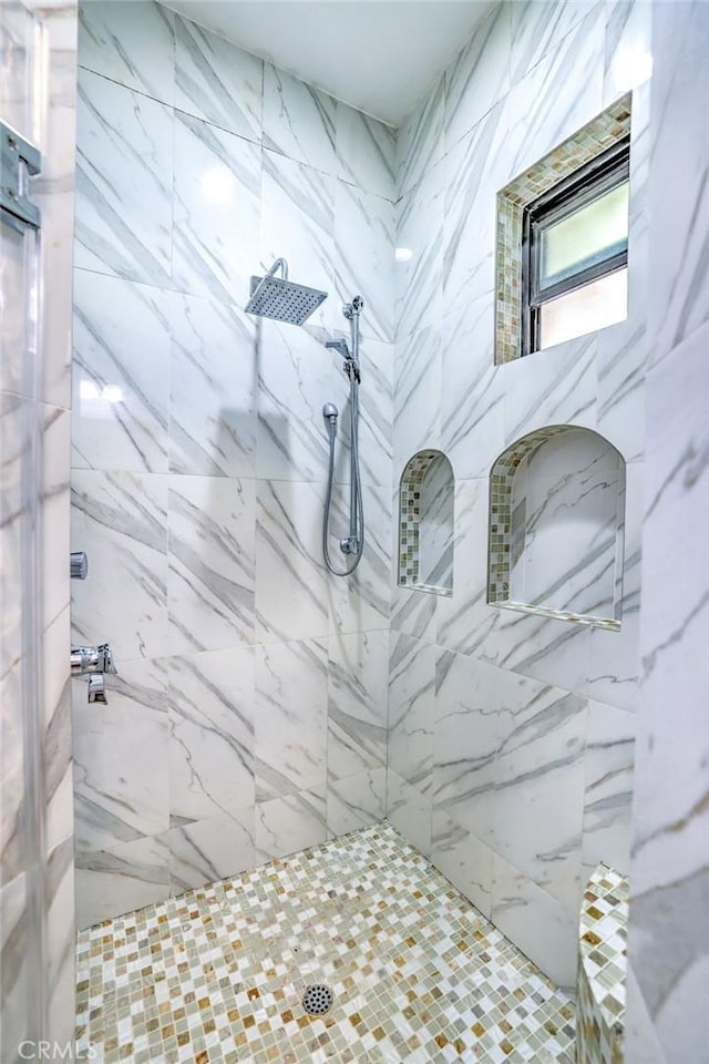 bathroom with a tile shower