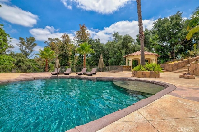 view of swimming pool with a patio area