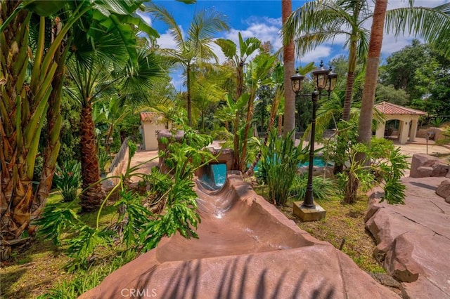 view of property's community with a swimming pool, a gazebo, and a patio