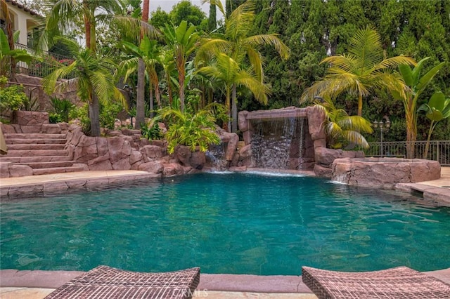 view of swimming pool with pool water feature