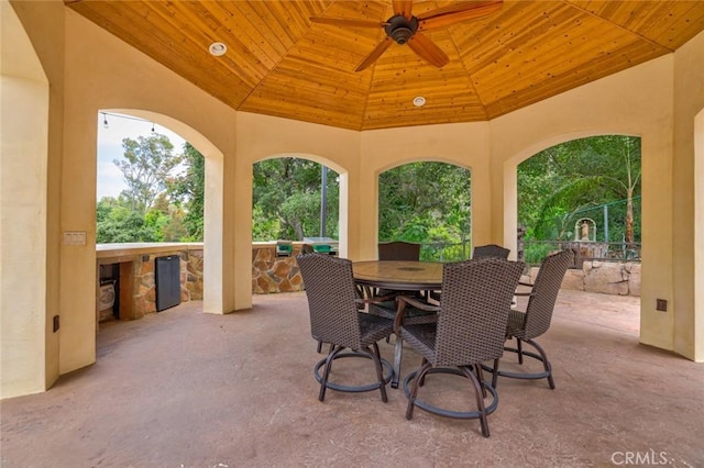 view of patio featuring a gazebo, a ceiling fan, and outdoor dining area