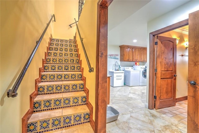 stairway featuring separate washer and dryer and baseboards