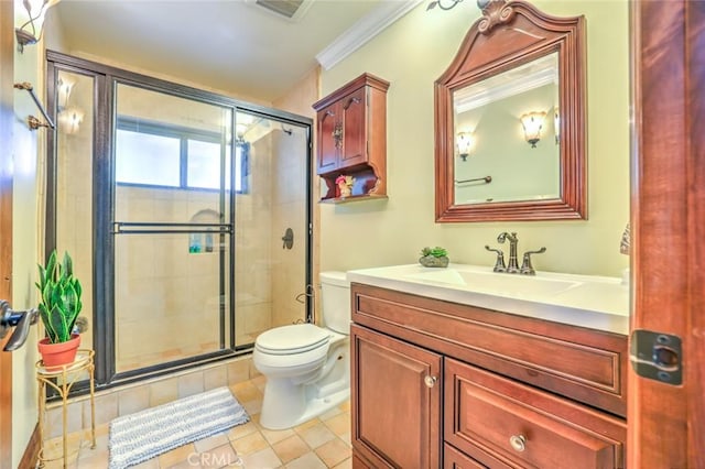 bathroom featuring toilet, vanity, tile patterned floors, ornamental molding, and a shower with door